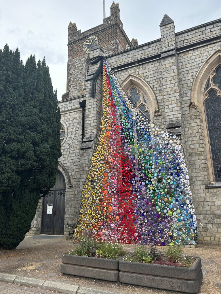 Flower tower art installation flowing down the side of the church